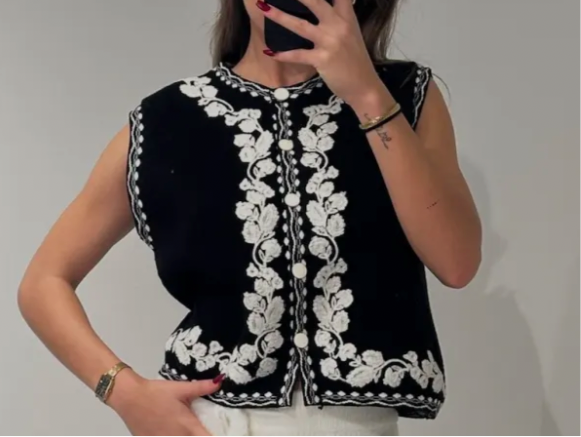 Bestickte schwarze Strickweste mit weißen Blumen